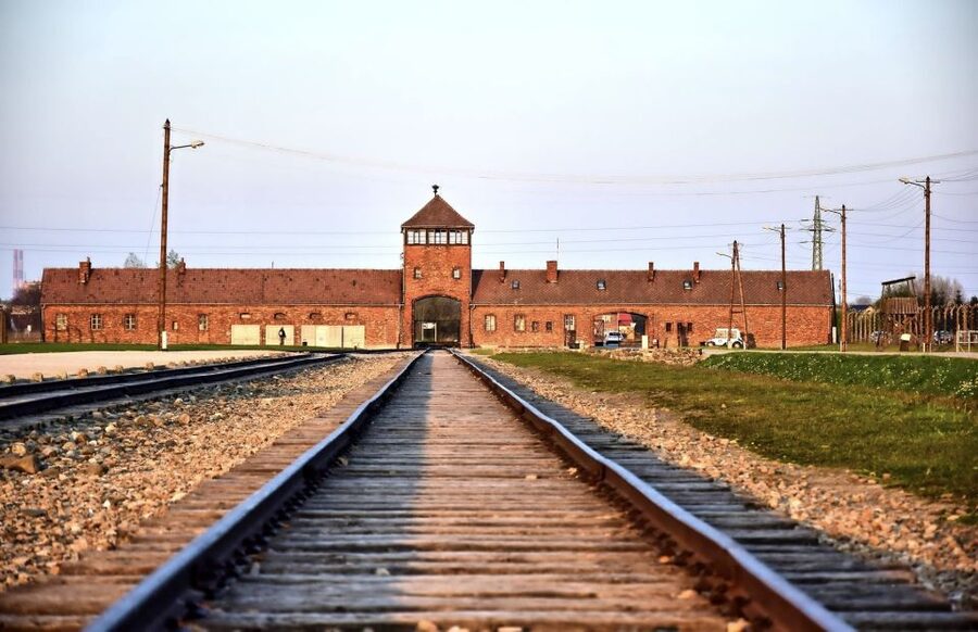 From Krakow: Auschwitz-Birkenau Guided Tour & Pickup - Entering Auschwitz I through Arbeit Macht Frei